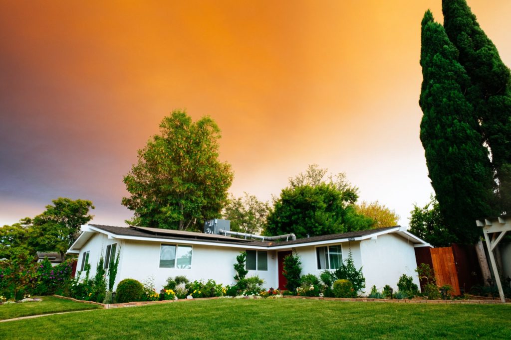 a house with a large orange sky