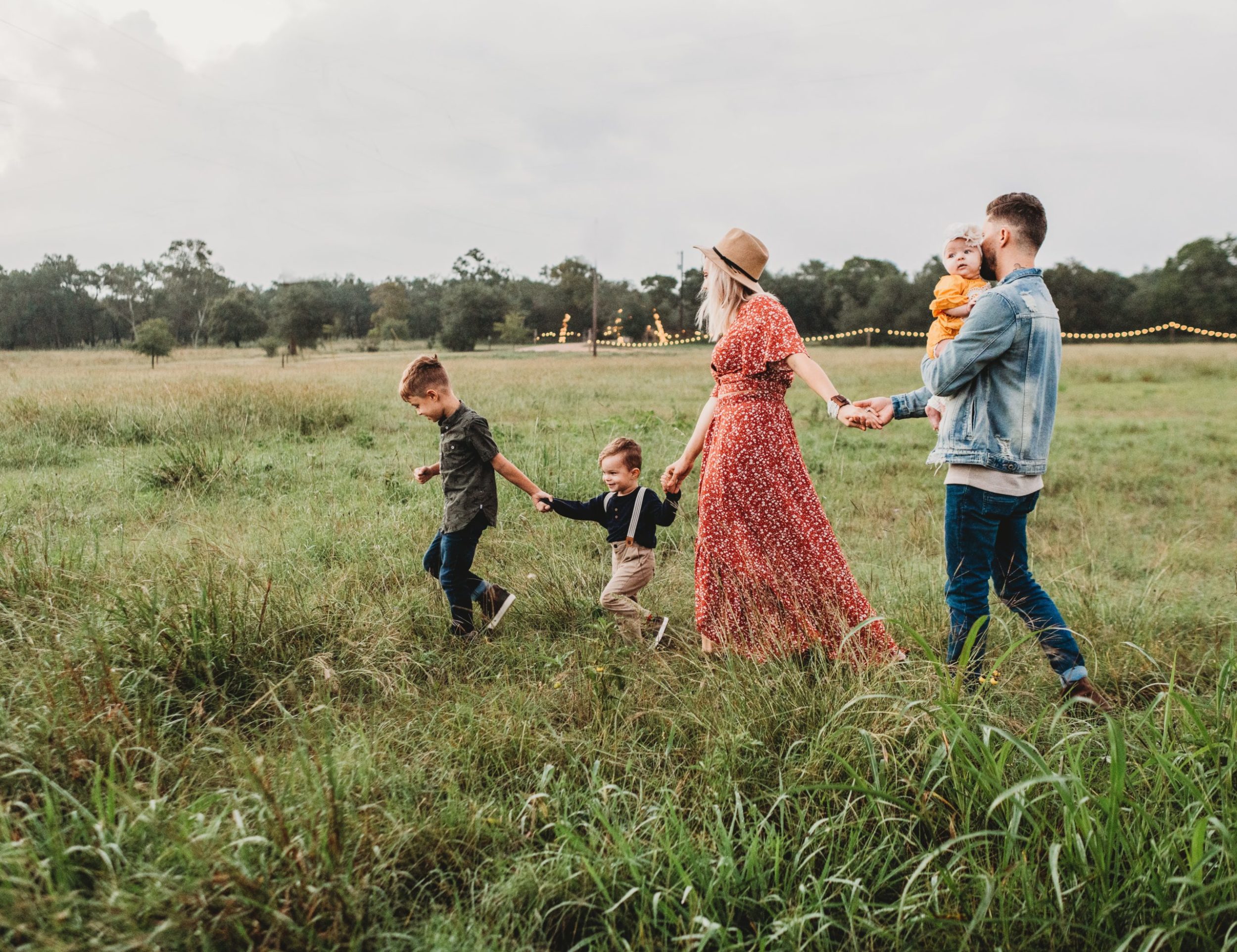 a group of people walking in a field